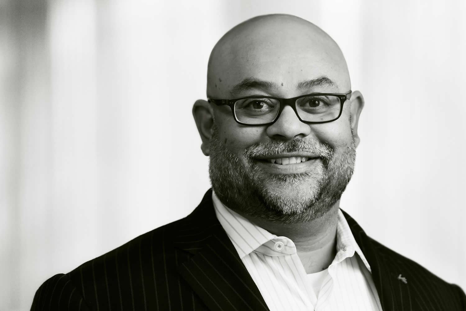 head shot of African American man with glasses